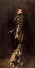 Portrait of a young stationary woman in long dress