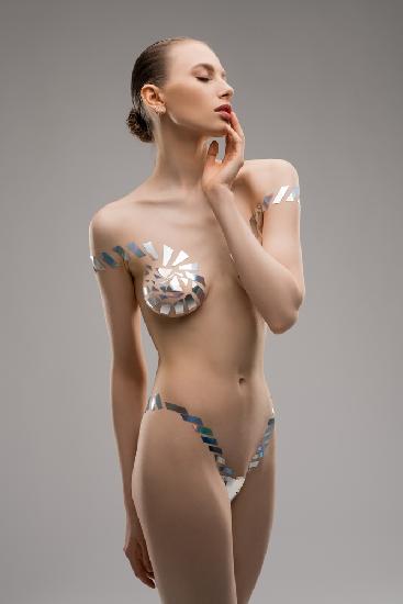Female model in underwear from metallic tape