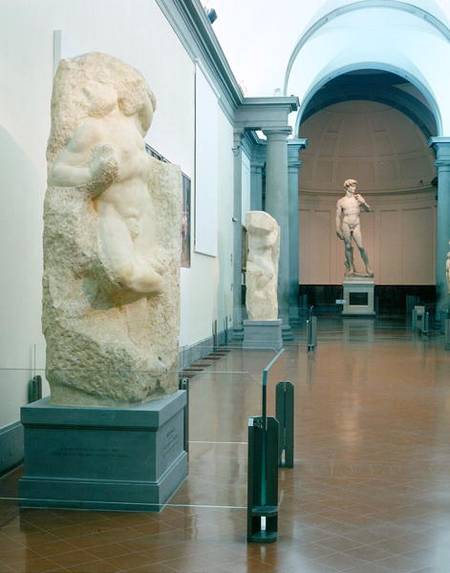Interior view of the gallery with Michelangelo's 'Awakening Slave' and 'David' in the background (ph de Anonymous
