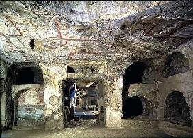 Interior of a catacomb chamber cut from tufa stone showing fragments of frescoed decoration