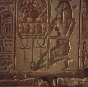Kneeling figure presenting baskets of food, from the Temple of Ramesses II