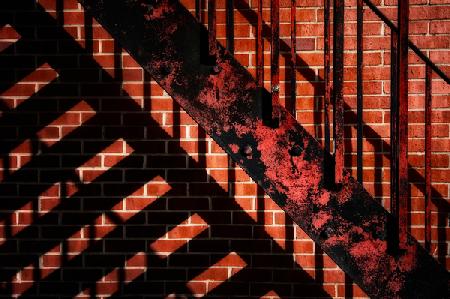 Fire escape on red wall