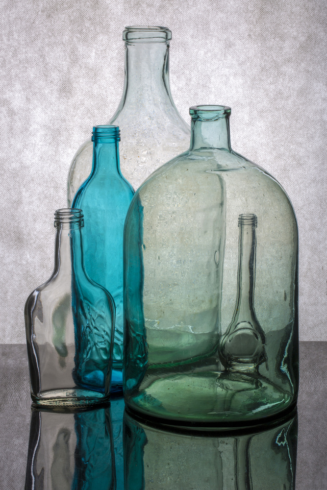 Still life with different transparent glass bottles de Brig Barkow