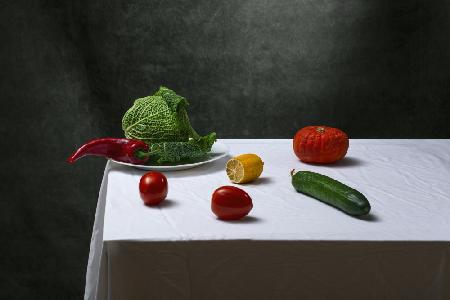 Still life with Savoy cabbage, tomatoes, cucumber, red pepper, lemon and pumpkin