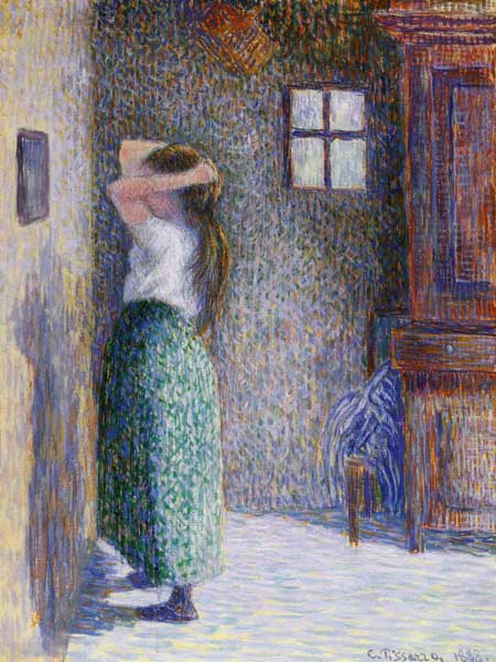 Woman in front of a mirror de Camille Pissarro
