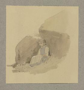 Mädchen im Schatten eines Felsens sitzend
