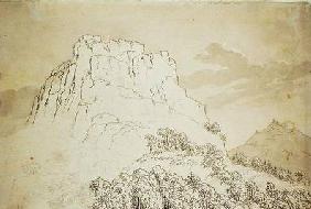 Cima rocosa frente a una colina arboleada