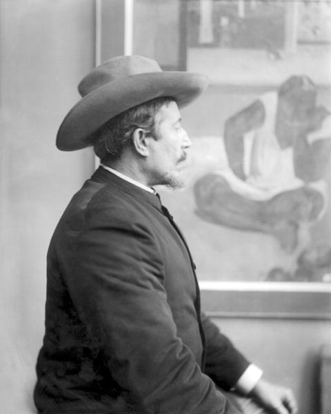 Paul Gauguin (1848-1903) in front of his canvases (b/w photo)  de French School