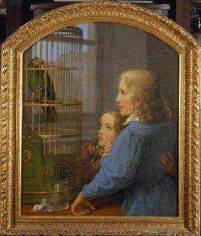 Zwei Kinder vor einem Papageienbauer