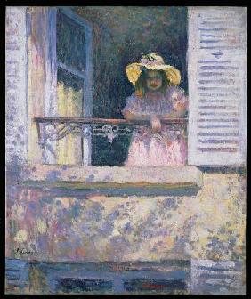 Young girl with sunhat at the window