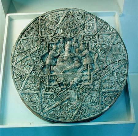 Sun disc depicting a king sitting cross-legged on a throne flanked by two angels in the centre, foun de Islamic School