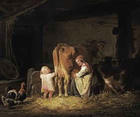 Young farmer with child when milking