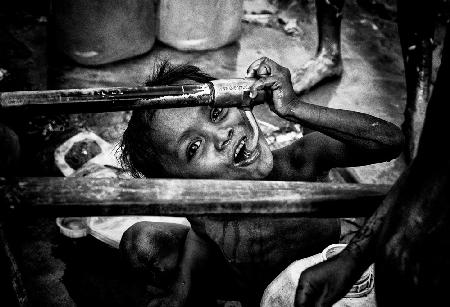Rohingya refugee child drinking water from a tap - Bangladesh