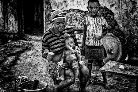 Feeding her child with milk - Benin