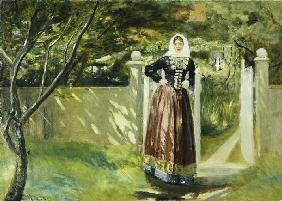 Woman in Danish dress at the garden gate