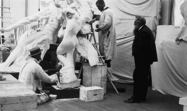 Auguste Rodin (1840-1917) in his Paris studio watching the construction of a sculpture, 1905 (b/w ph de 