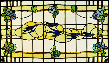 An Arts And Crafts Leaded And Stained Glass Panel Of A Group Of Swallows Before Clouds In A Border O de 