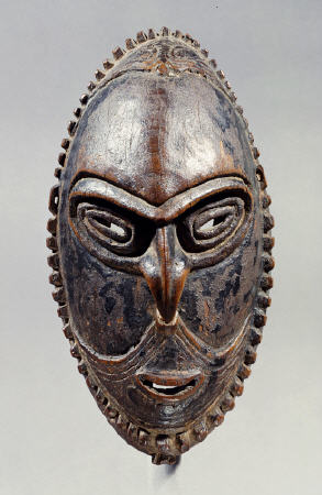 A New Guinea Mask Of Oval Form With Pierced Eyes, Mouth And Septum de 