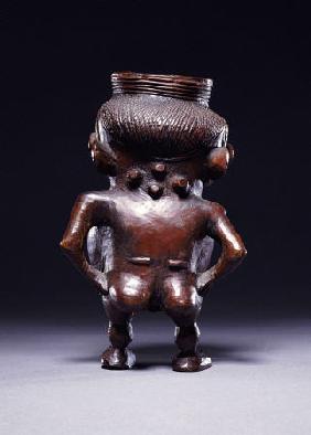 Backview Of A Wongo Cup Carved As A Female Standing Figure With Spherical Body