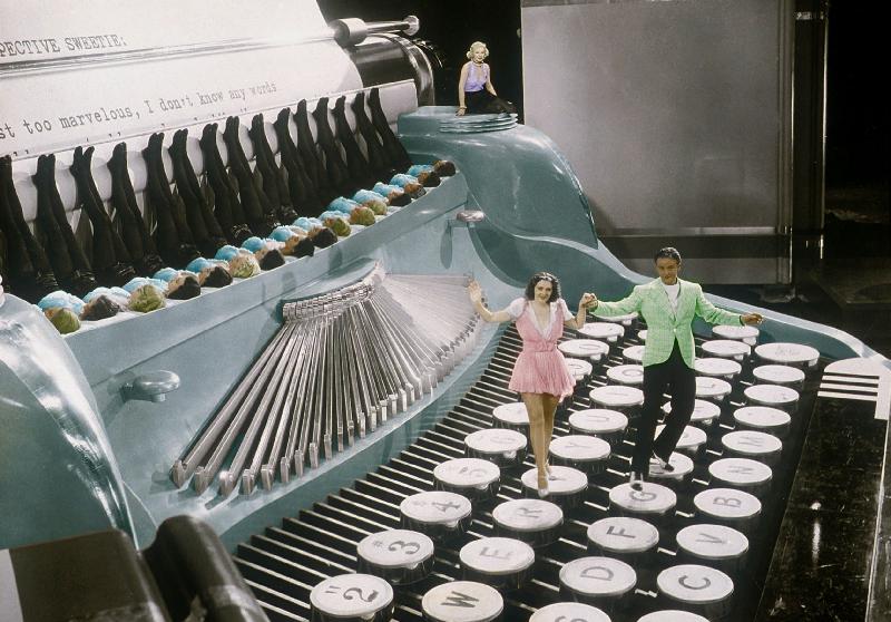 Couple dancing on the key of a giant typewriter, keys are leg of dancers, musical, 30's colourized d de 