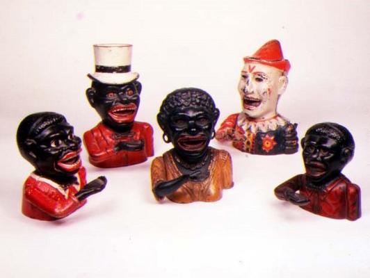 Group of Mechanical cast iron money banks. Left to right: Jolly Nigger with Butterfly Tie, Jolly Nig de 