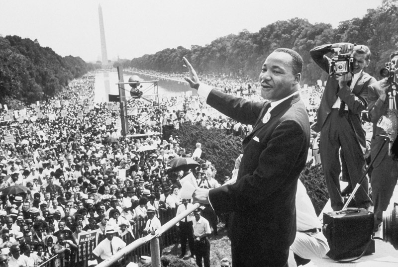 Martin Luther King American priest activist for Civil Right Movement of black Americans saluting the de 