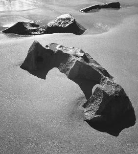 Rock on sand (b/w photo) 