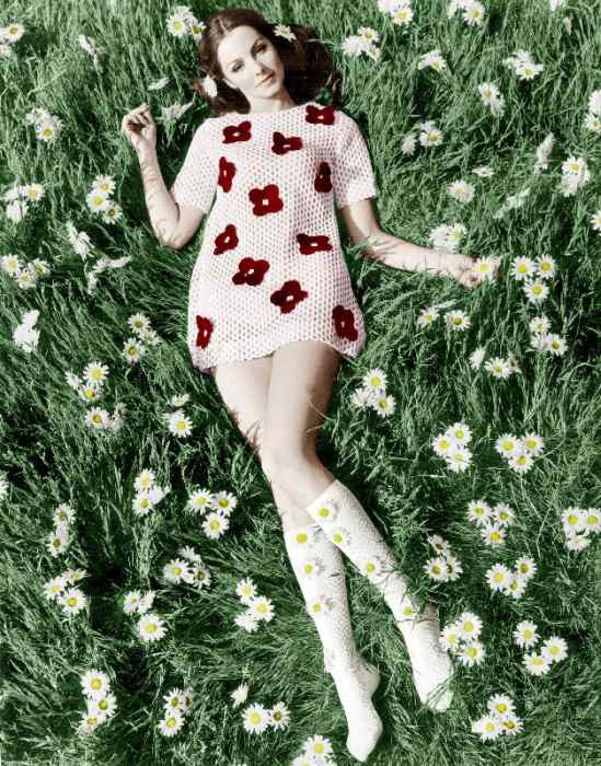 Young model Biddy Lampard in the grass wearing a short dress inspired by Courreges colourized docume de 