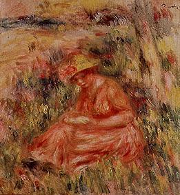 Young woman with hat in a reddish landscape.