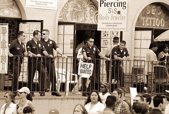 Police gathered behind a ''Help Wanted'' sign, 2004 (b/w photo)  de Stephen  Spiller