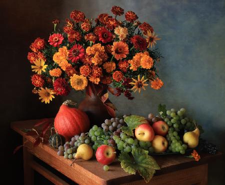Still life with a bouquet of autumn flowers and grapes