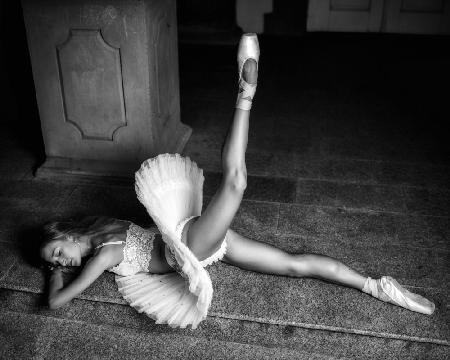 Ballerina lying on the stairs BW