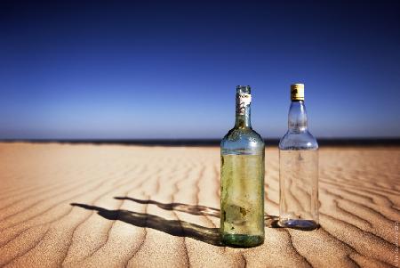 Bottles on sand
